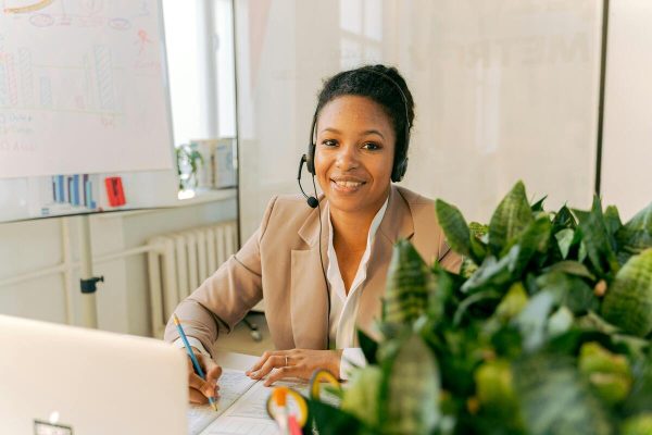 Customer support agent taking calls, demonstrating how to improve customer support with professional and efficient service.