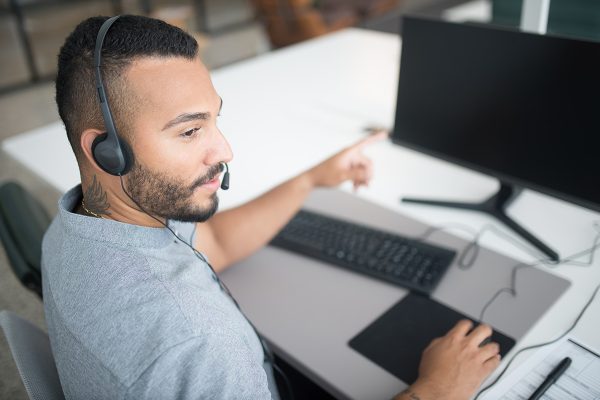 Customer support staffing agency agent assisting callers by phone